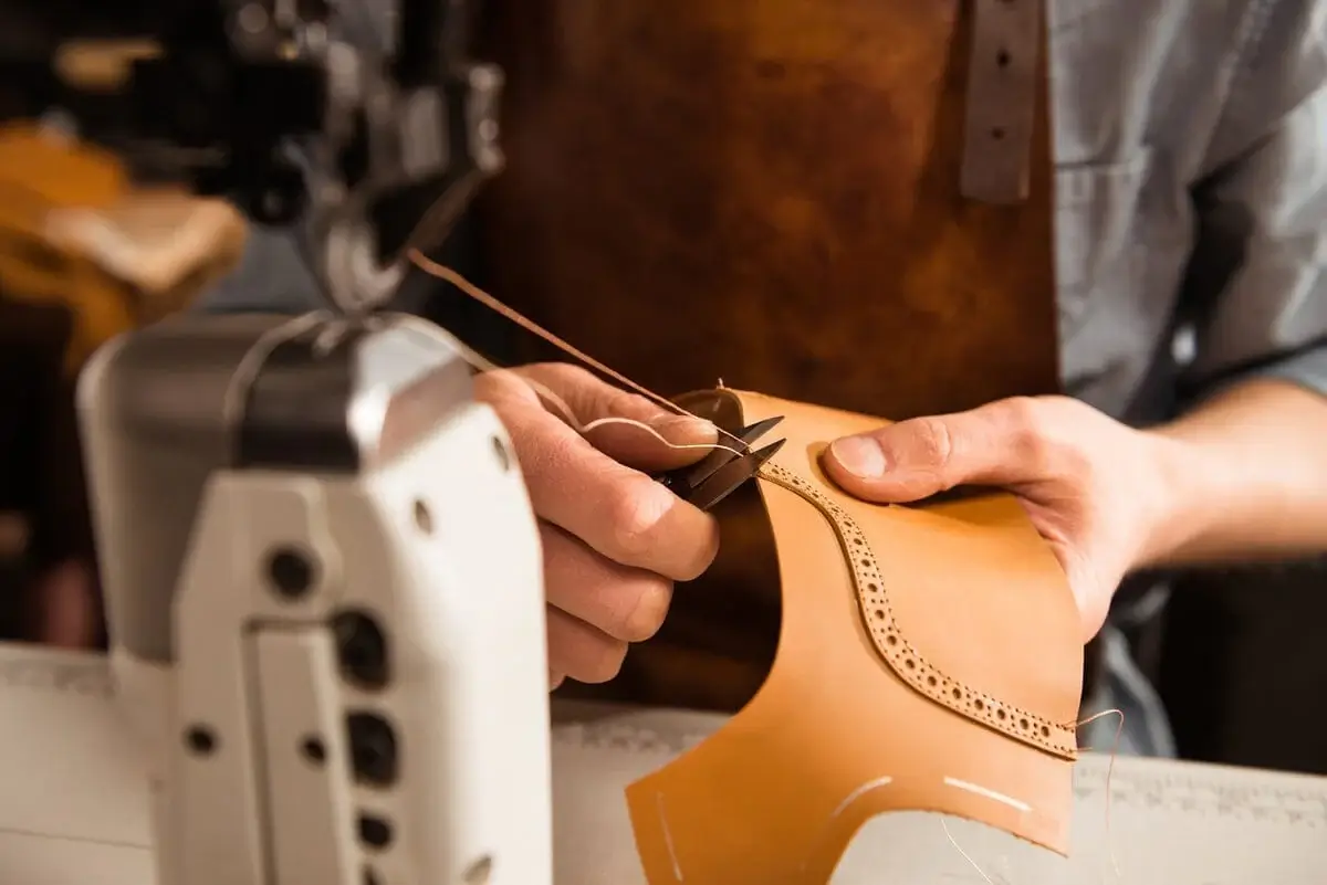 Stitching machine working on leather